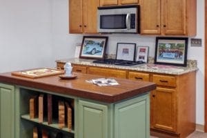 S&W Showroom cabinets in green with wood top Green kitchen cabinets with wood countertop